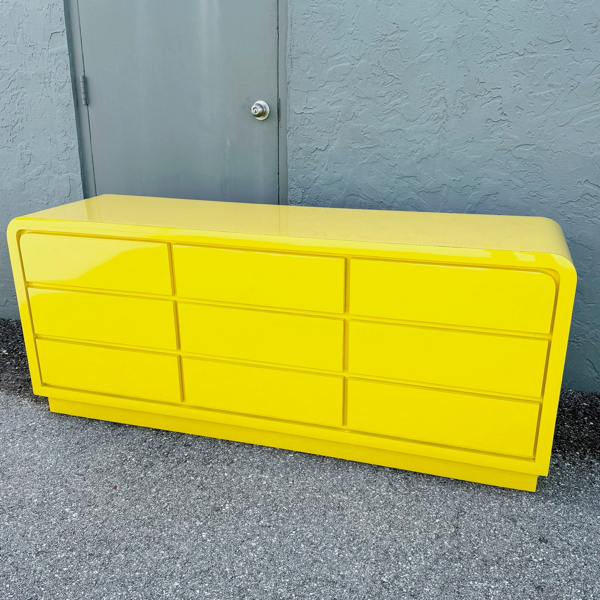 Postmodern Yellow Gloss Laminate Waterfall Dresser - 9 Drawers Dolphin & Flamingo