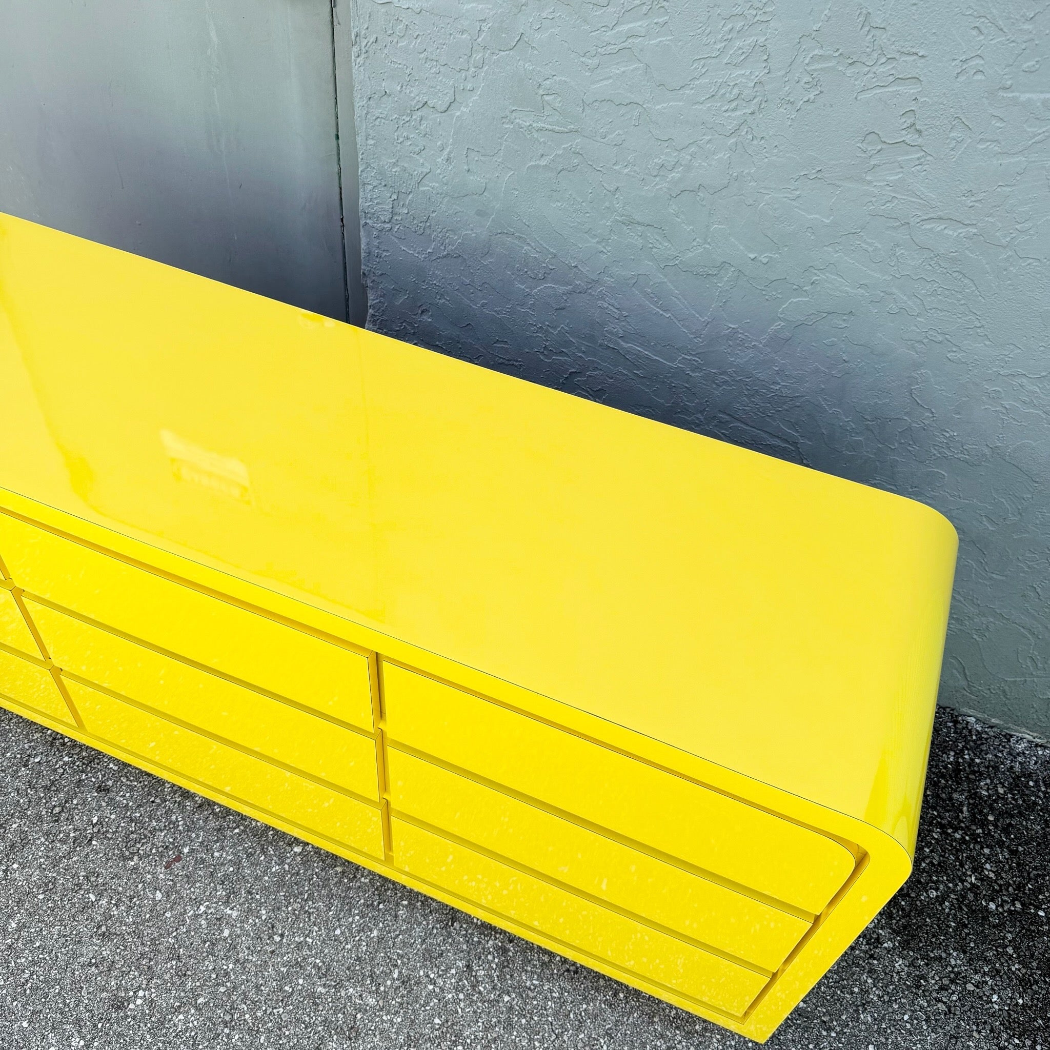 Postmodern Yellow Gloss Laminate Waterfall Dresser - 9 Drawers Dolphin & Flamingo