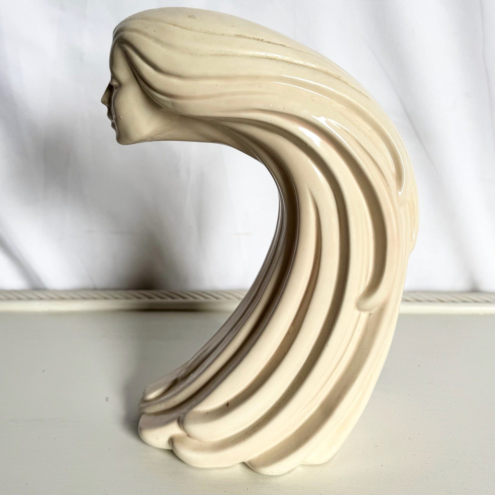 “Woman of the Wind" or "Moderne Frauenbüste Mit Langem Haar Aus Steinguss” From Ceramic - Dolphin & Flamingo