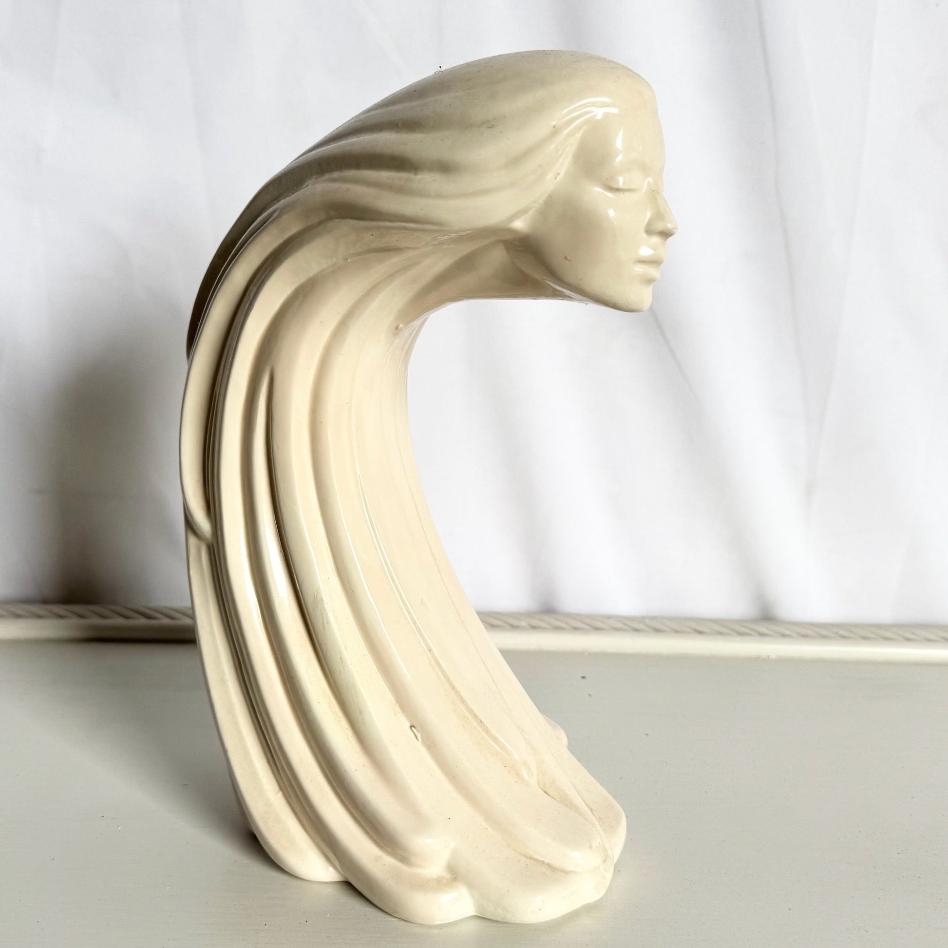 “Woman of the Wind" or "Moderne Frauenbüste Mit Langem Haar Aus Steinguss” From Ceramic - Dolphin & Flamingo