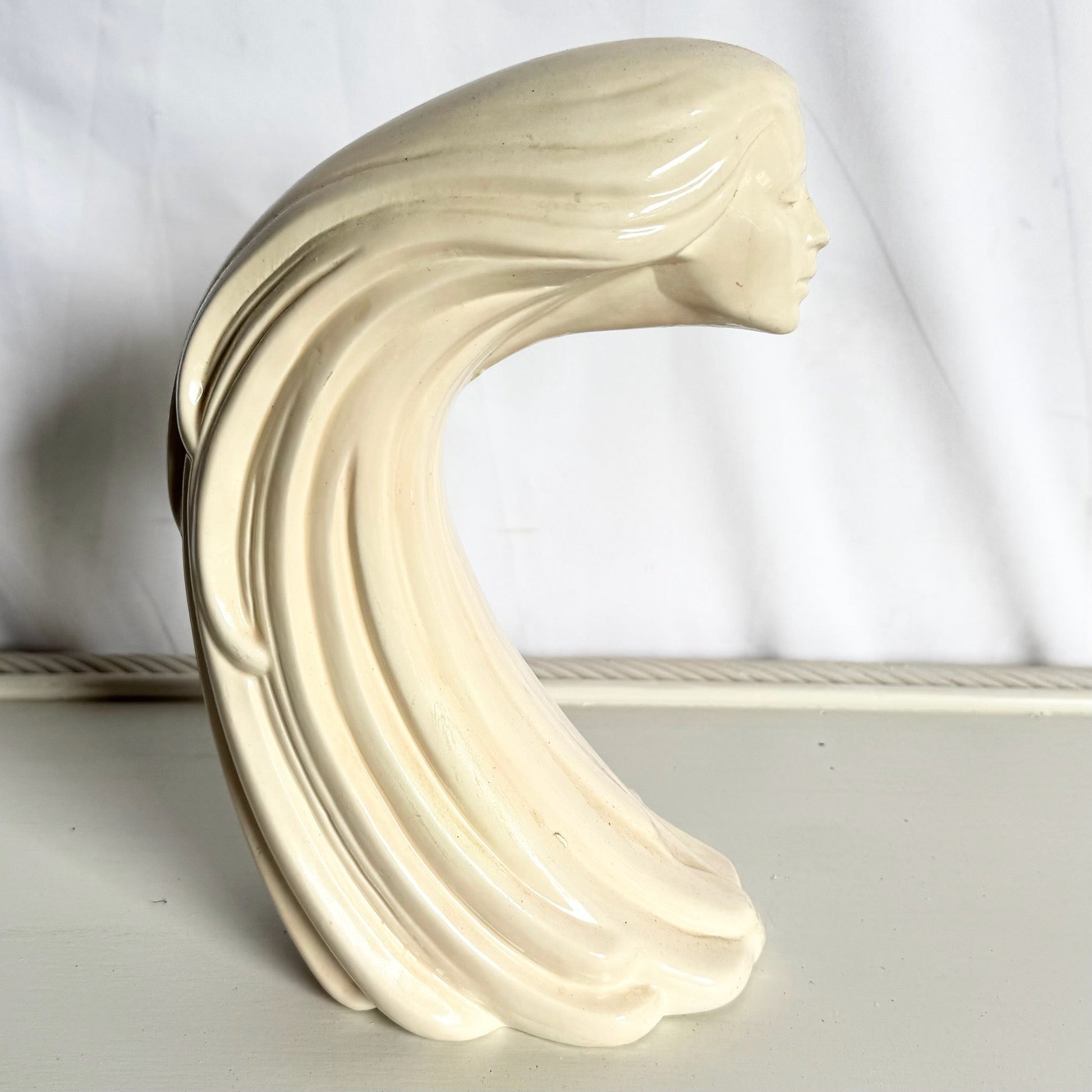 “Woman of the Wind" or "Moderne Frauenbüste Mit Langem Haar Aus Steinguss” From Ceramic - Dolphin & Flamingo